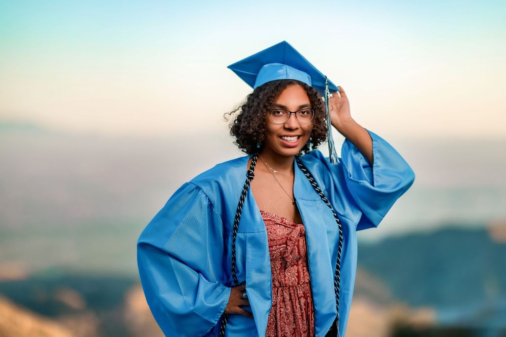 Golden hour senior photo overlooking cliffs at Windy Point, Tucson