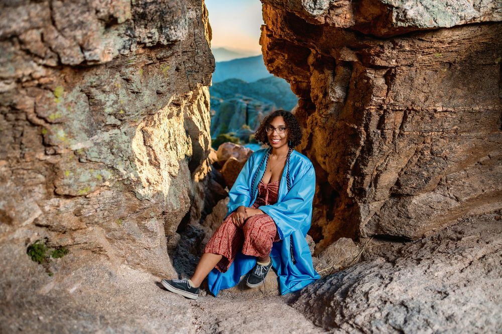 Golden hour senior photo overlooking cliffs at Windy Point, Tucson