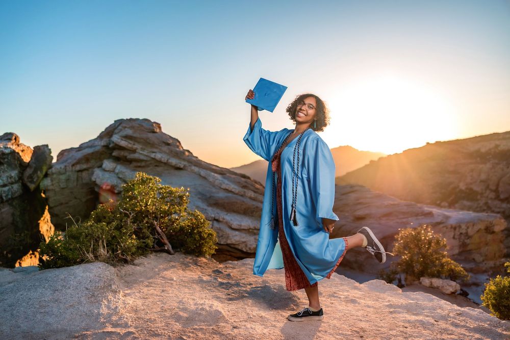 Golden hour senior photo overlooking cliffs at Windy Point, Tucson