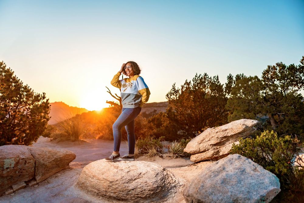 Golden hour senior photo overlooking cliffs at Windy Point, Tucson