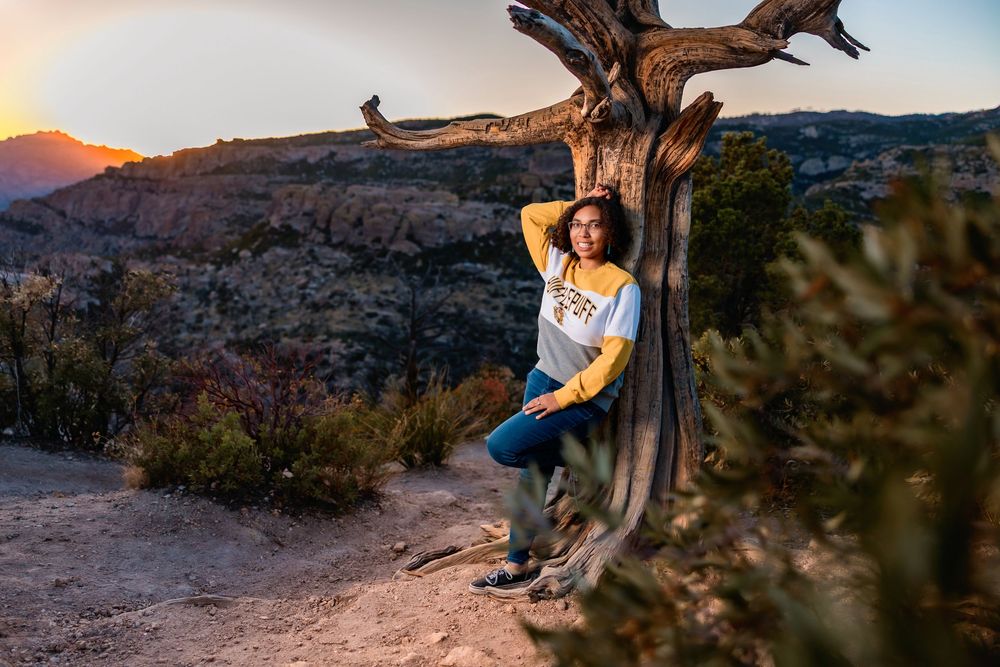 Golden hour senior photo overlooking cliffs at Windy Point, Tucson