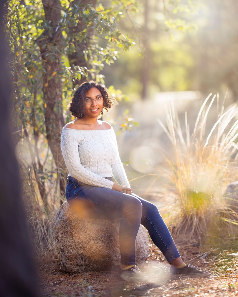 Marlee sitting among pine trees during senior session in Mount Lemmon. Tucson, AZ senior portraits