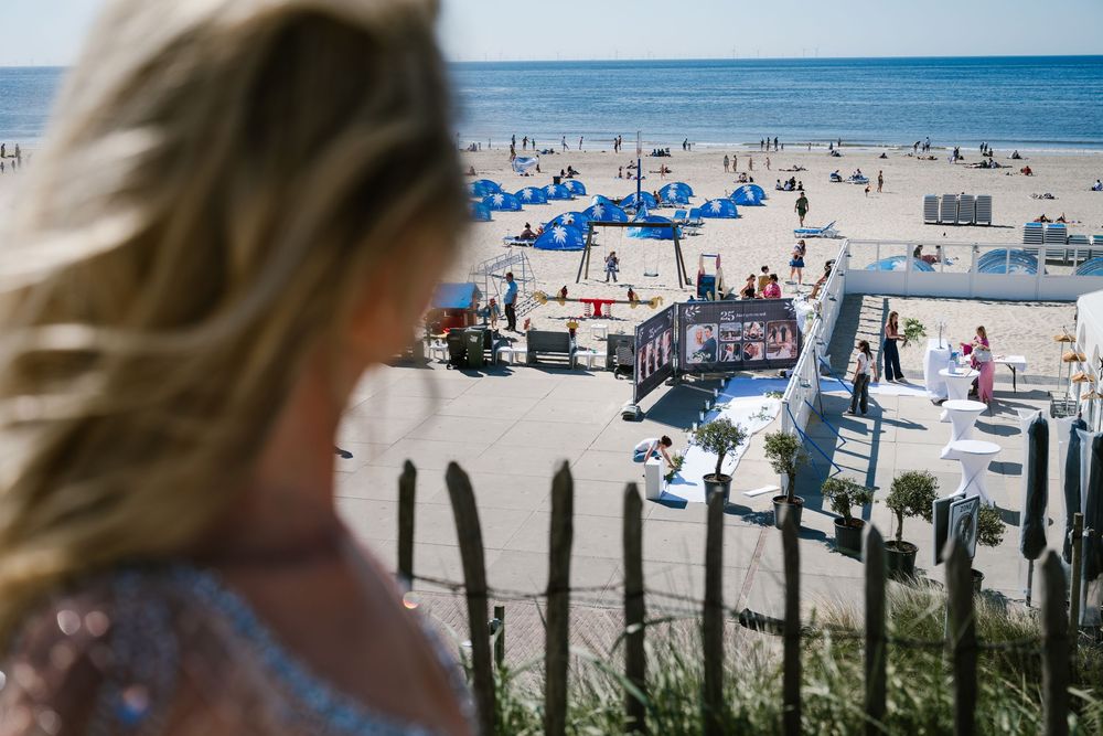 Scenic beach landscape with blue ocean views and beachgoers enjoying a sunny day.