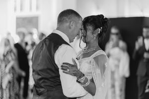Couple sharing a romantic moment during their first dance at a wedding reception.