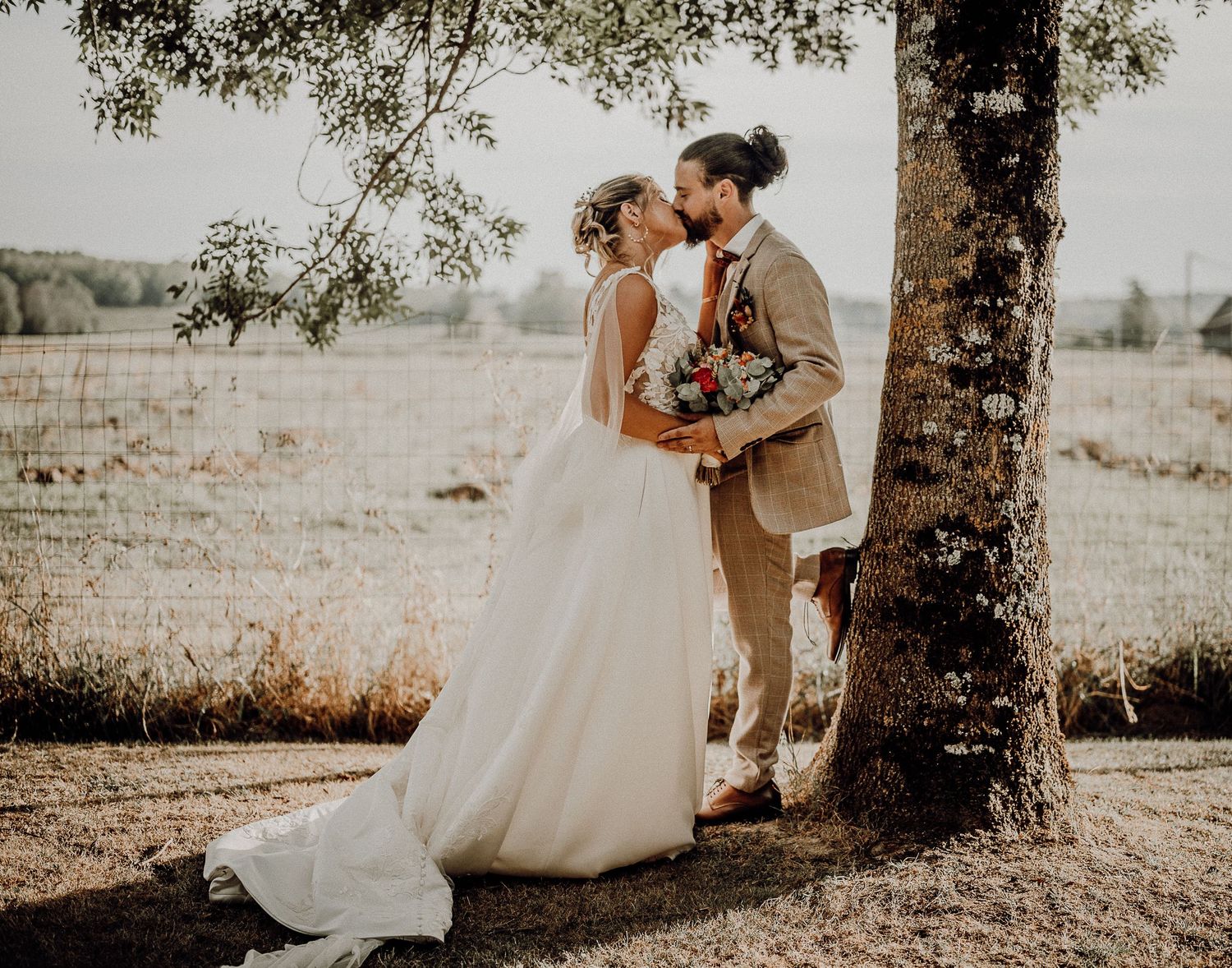 A romantic wedding photo sequence showing intimate moments between a couple beneath sunlit trees.