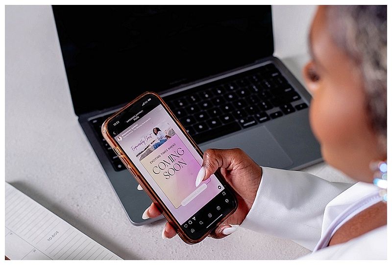 Entrepreneur holding cellphone with website screenshot during South Florida branding session