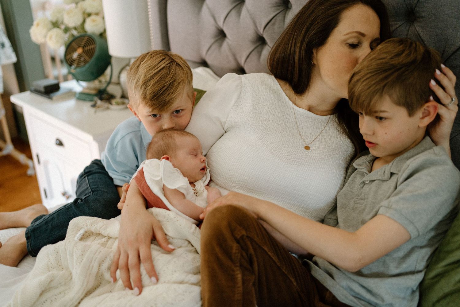 Parent and child share a quiet moment together while reading stories in a comfortable home setting.