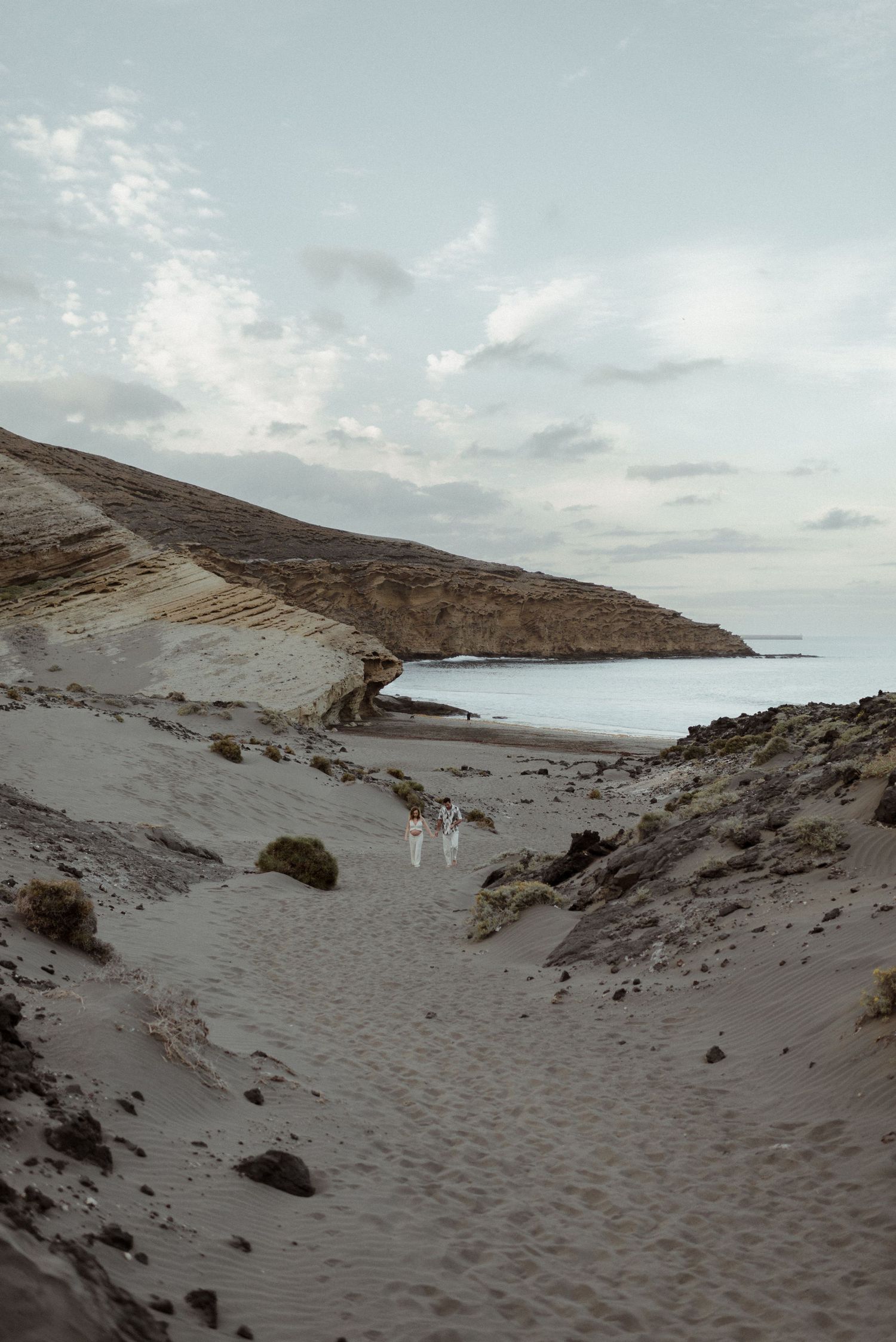 Four panoramic views of sandy beach dunes and coastline under cloudy skies at different angles.