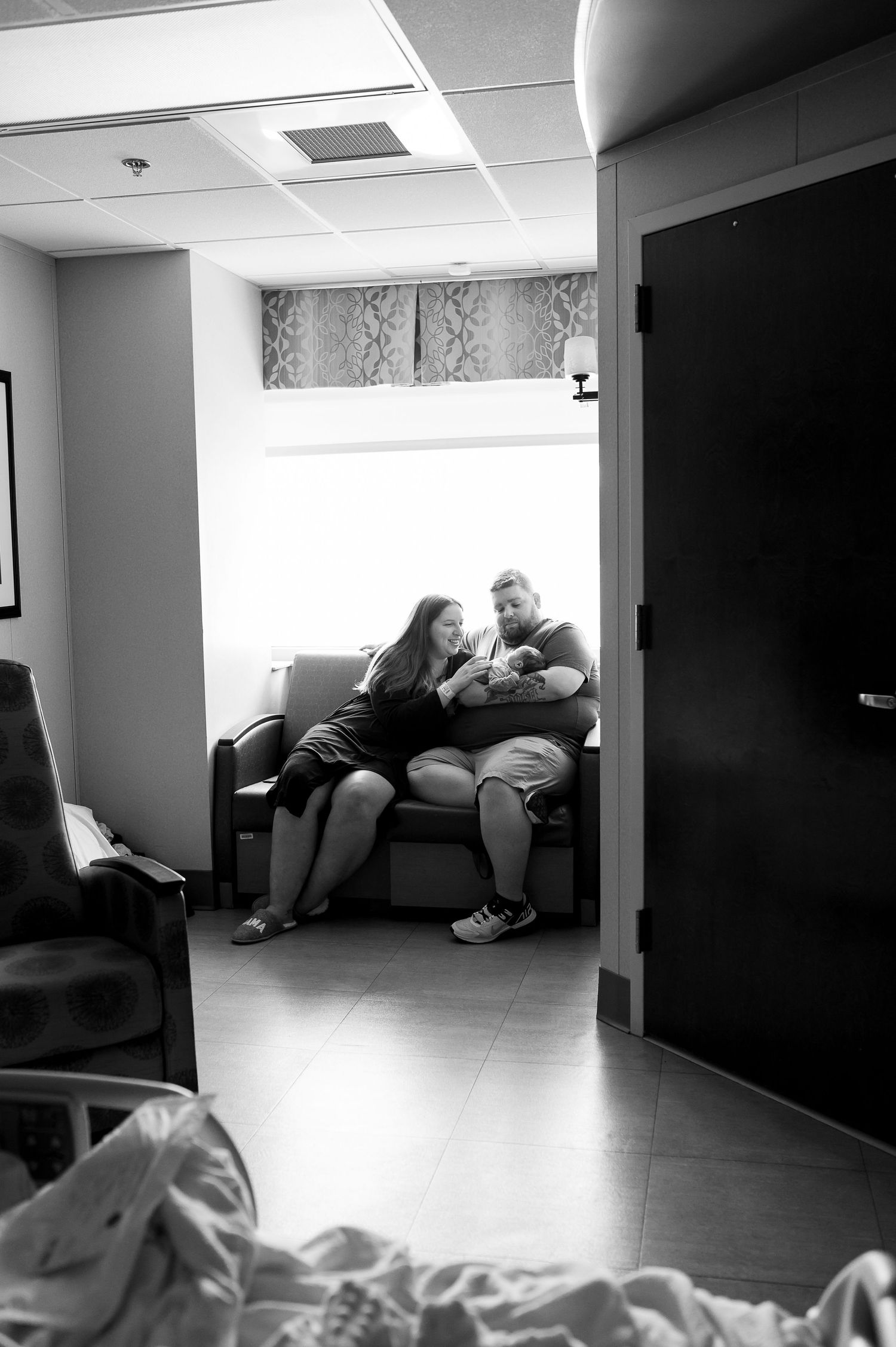 A tired figure rests on dark furniture in a dimly lit office space, shown as a series of similar black and white frames.