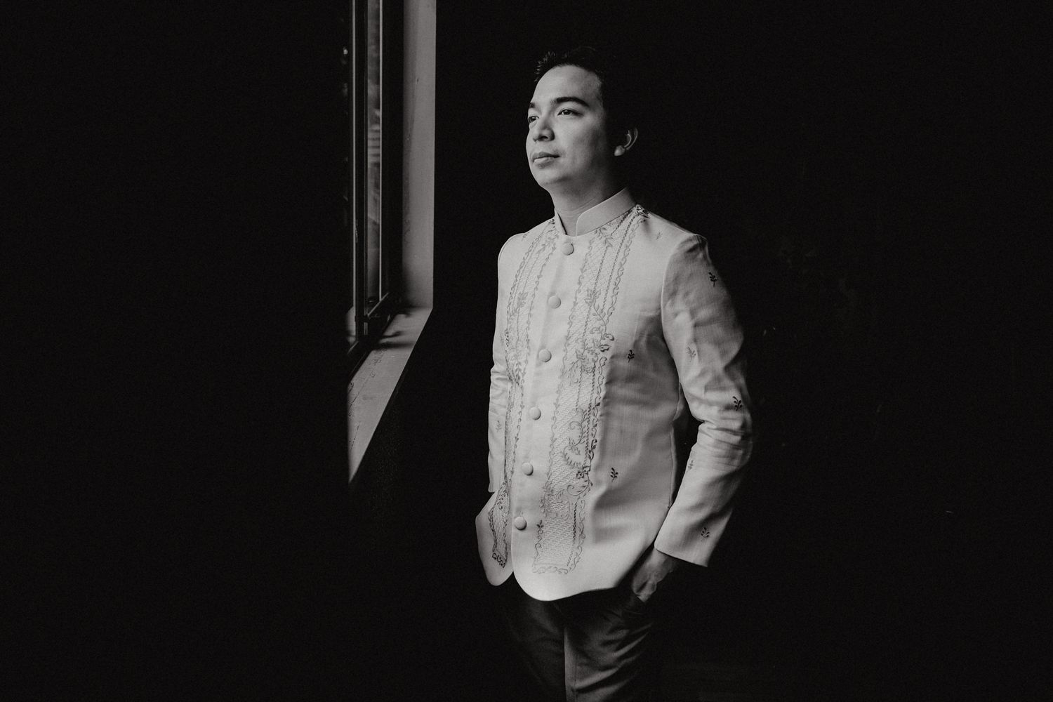 Classic Barong Tagalog attire shown in dramatic black and white lighting.