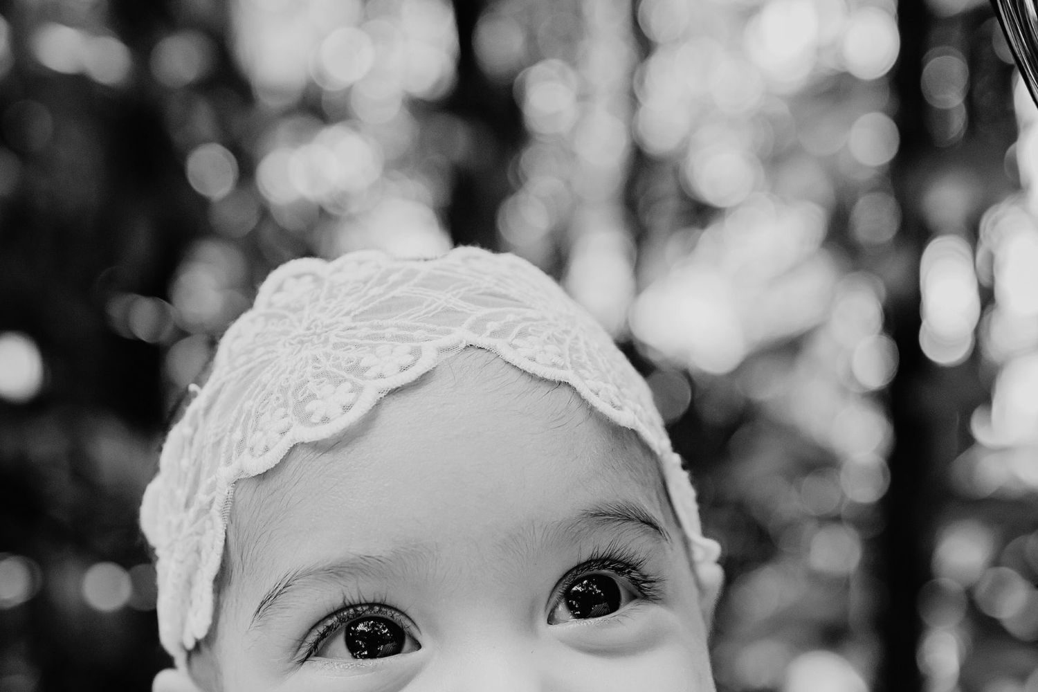 Black and white collage of close-up portraits showing emotion and expression with gentle lighting.