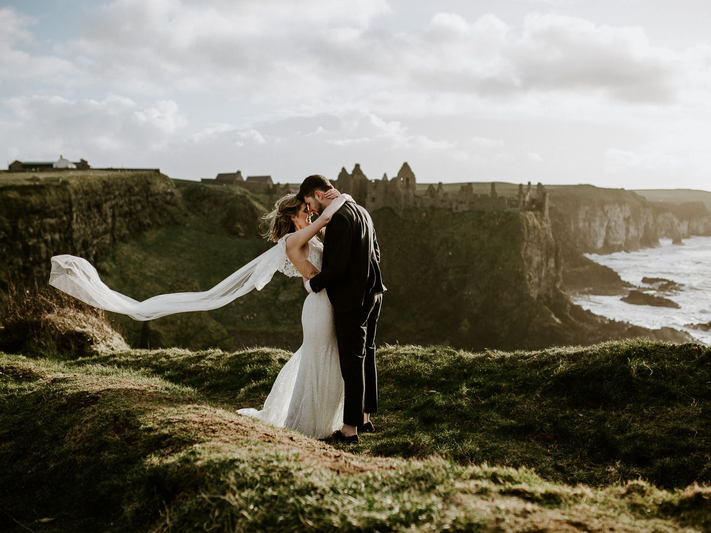 Bride and Groom eloping at Dunluce Castle in Northern Ireland at sunset