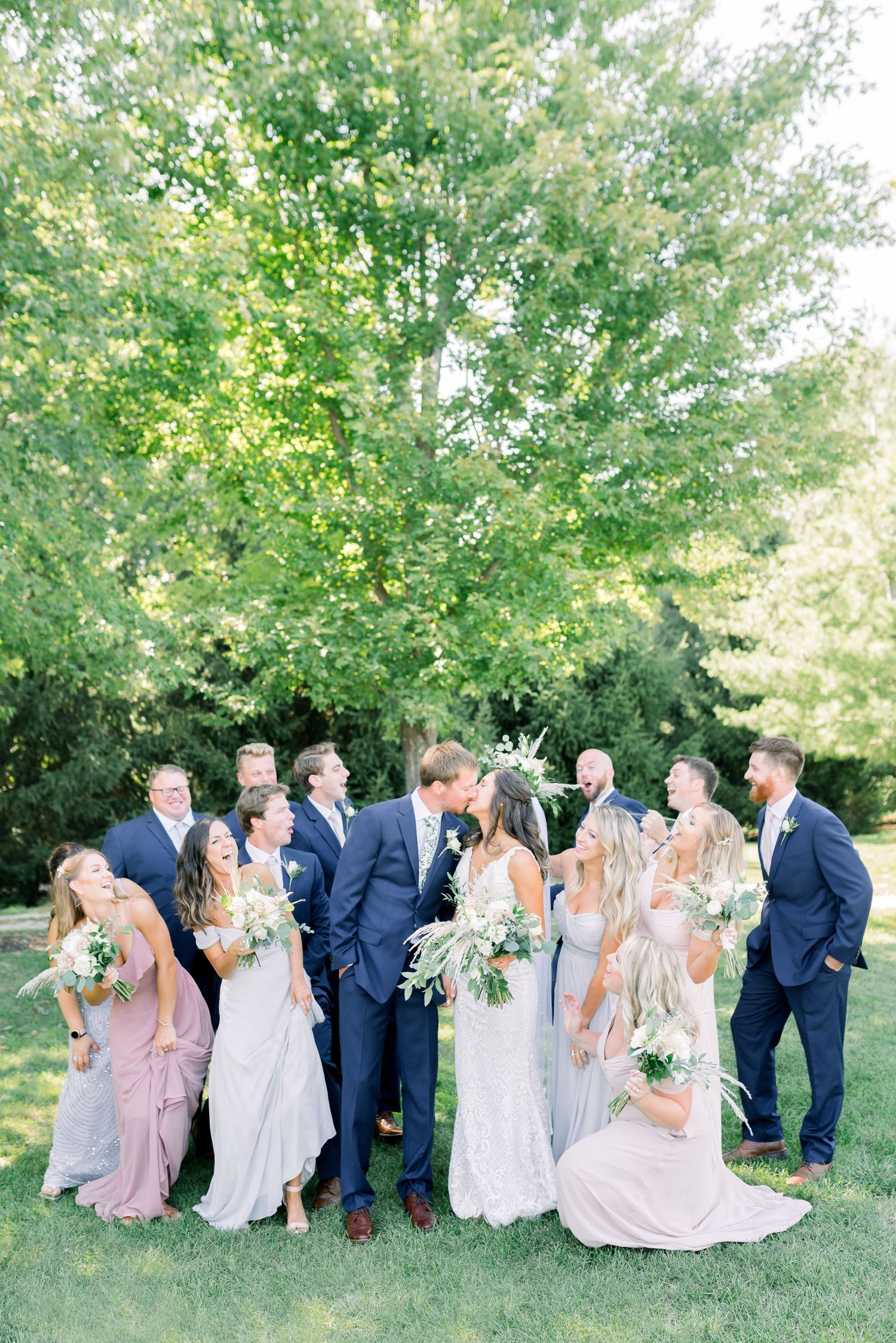 Vineyard bridal party photos with blue tuxes and pastel dresses at Prairie Moon Winery wedding in Ames, Iowa