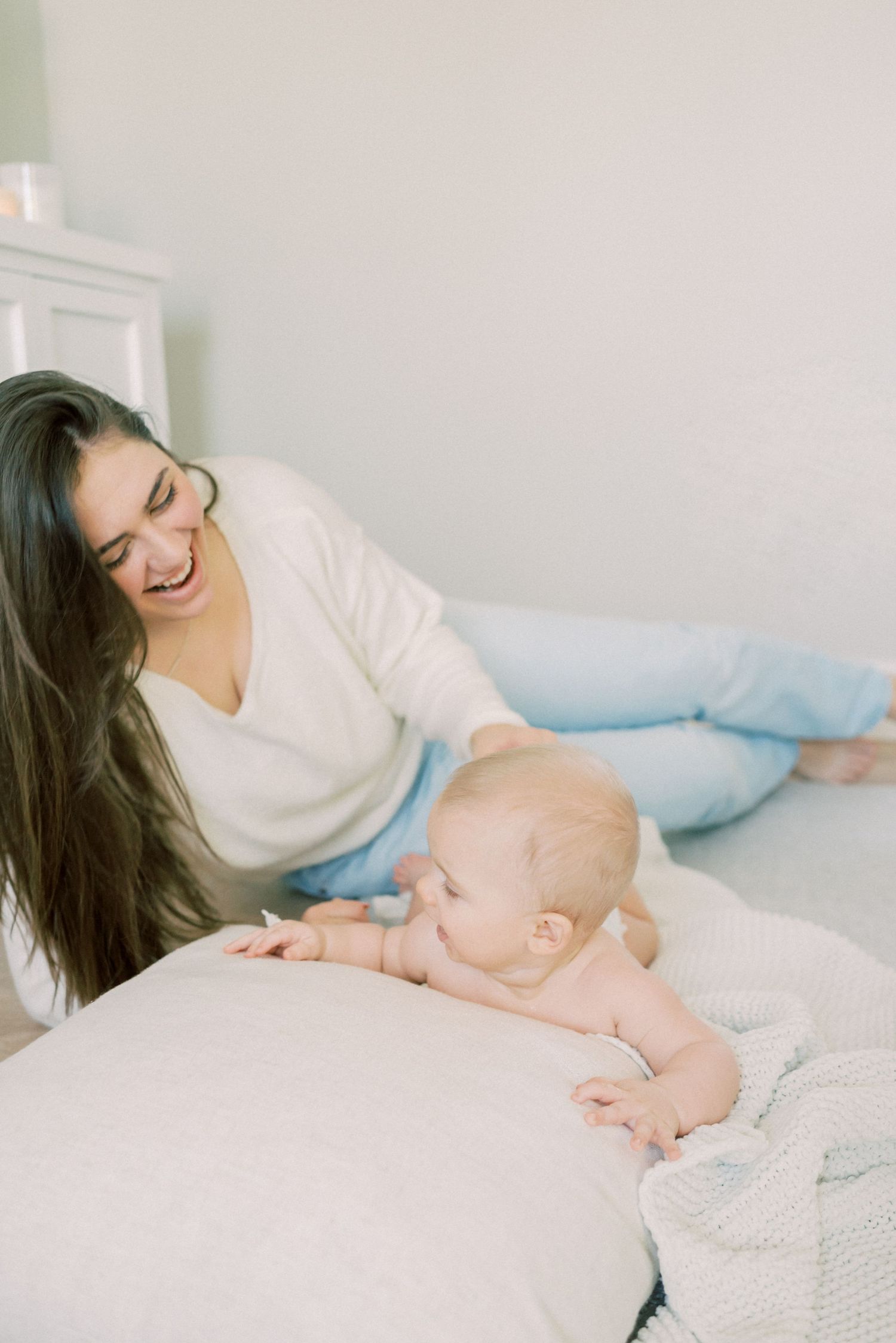 Intimate moment captured in soft light on white furniture with casual comfort.