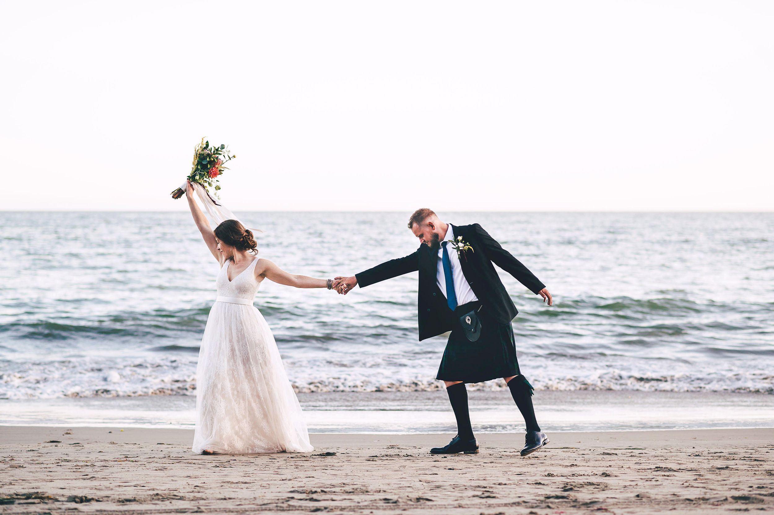 Bride and groom on the beach in Santa Cruz at sunset