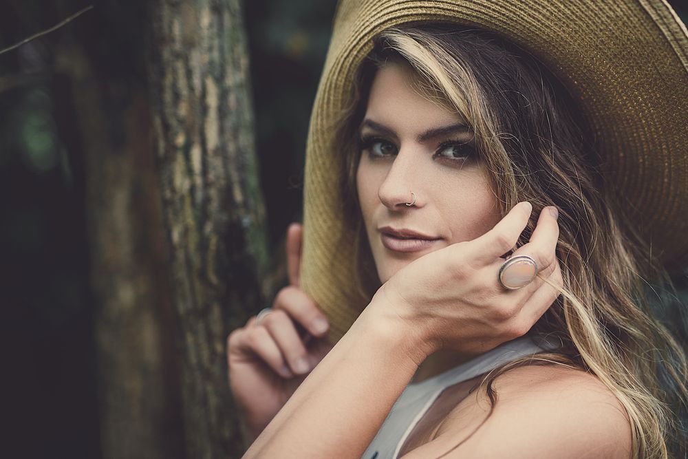 Portrait of woman in a dress wearing a hat