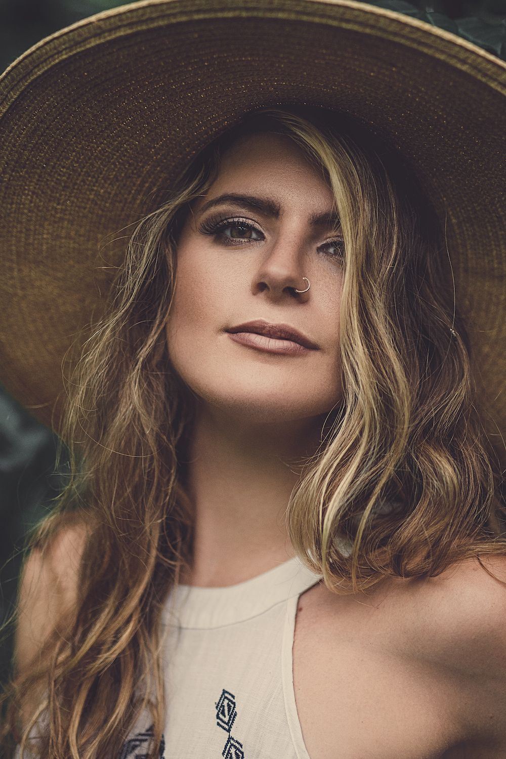 Portrait of woman in a dress wearing a hat