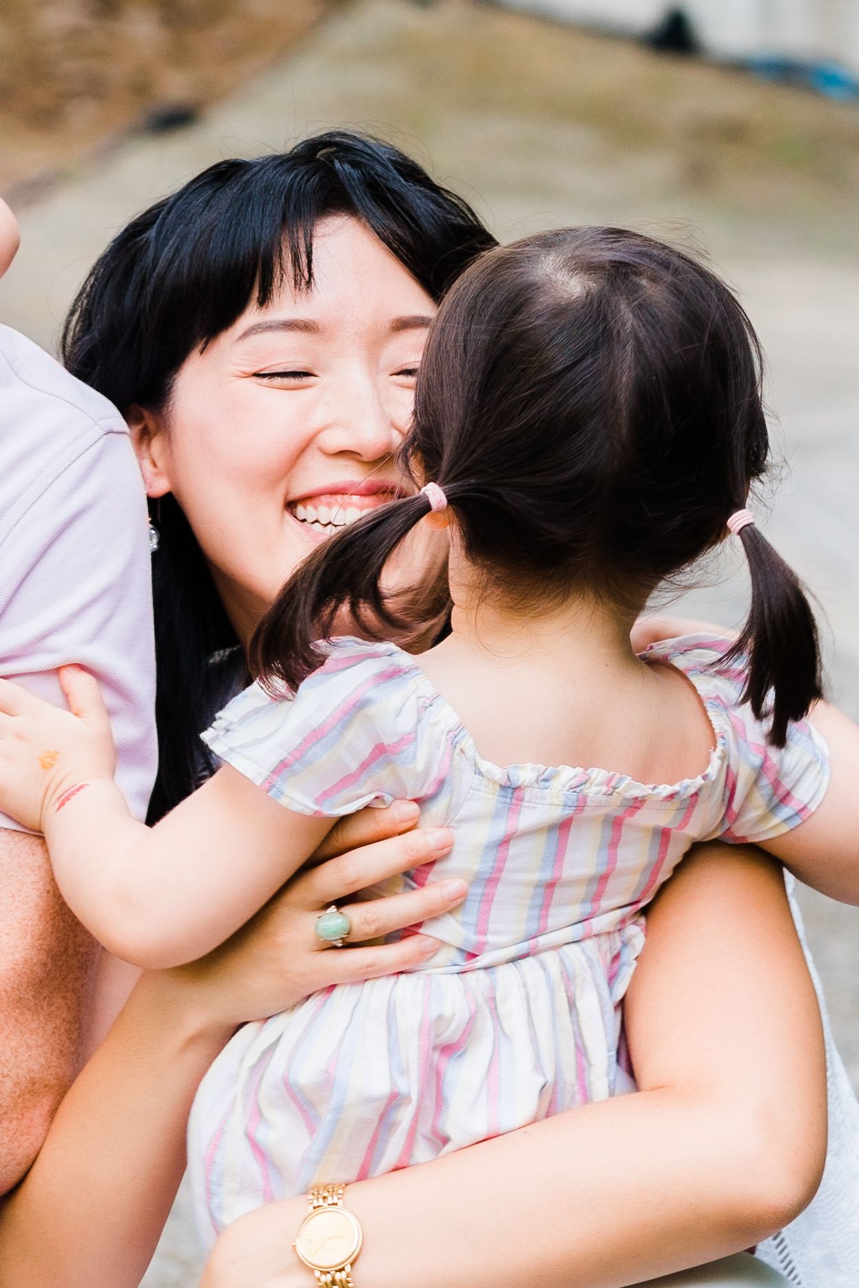 daughter runs into mother's arms and mom is smiling