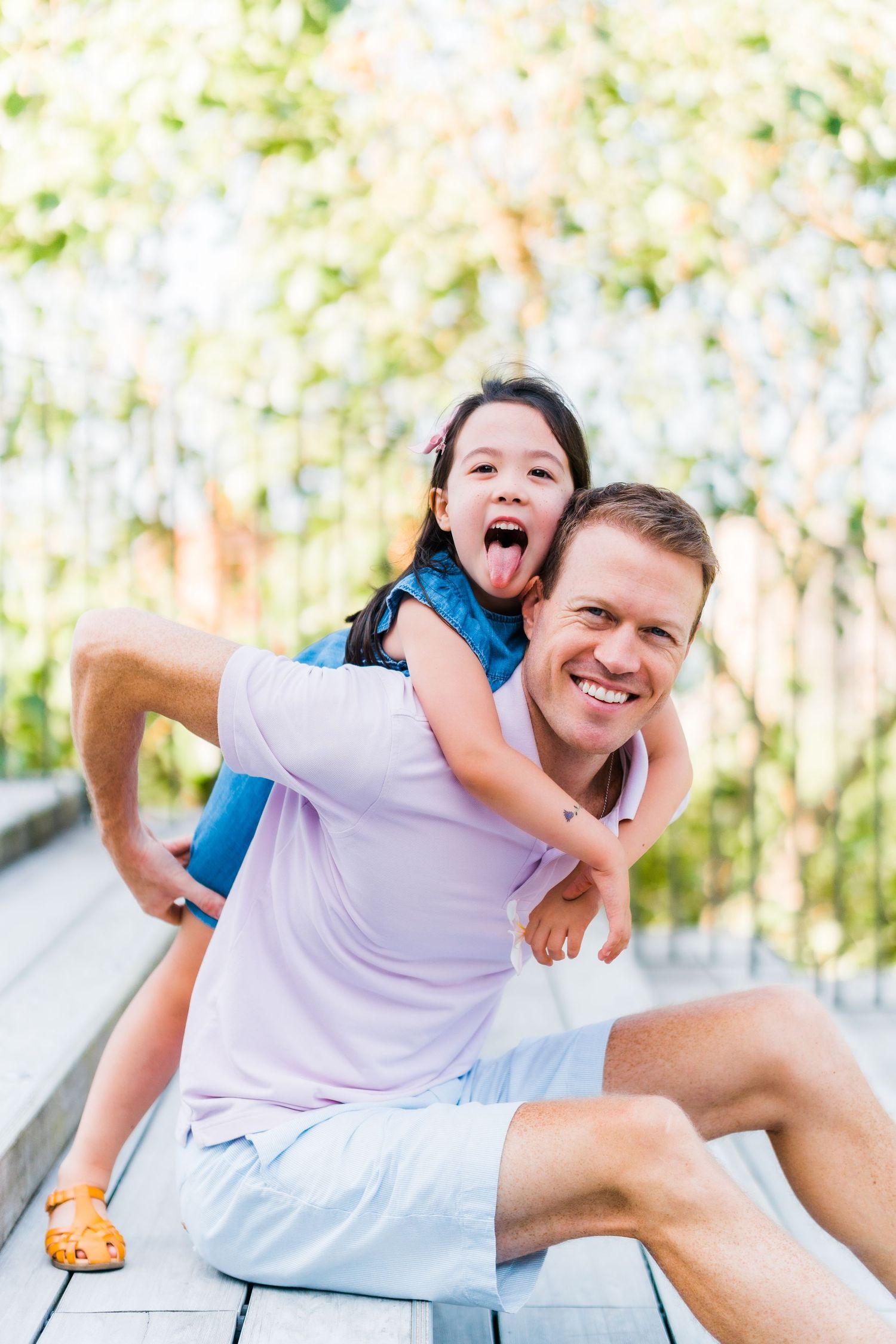 Playful piggyback ride moment captured in outdoor setting.