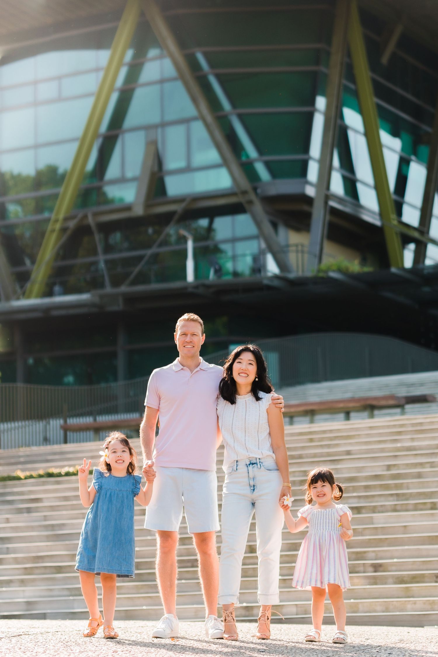 the family is standing in a line while holding hands