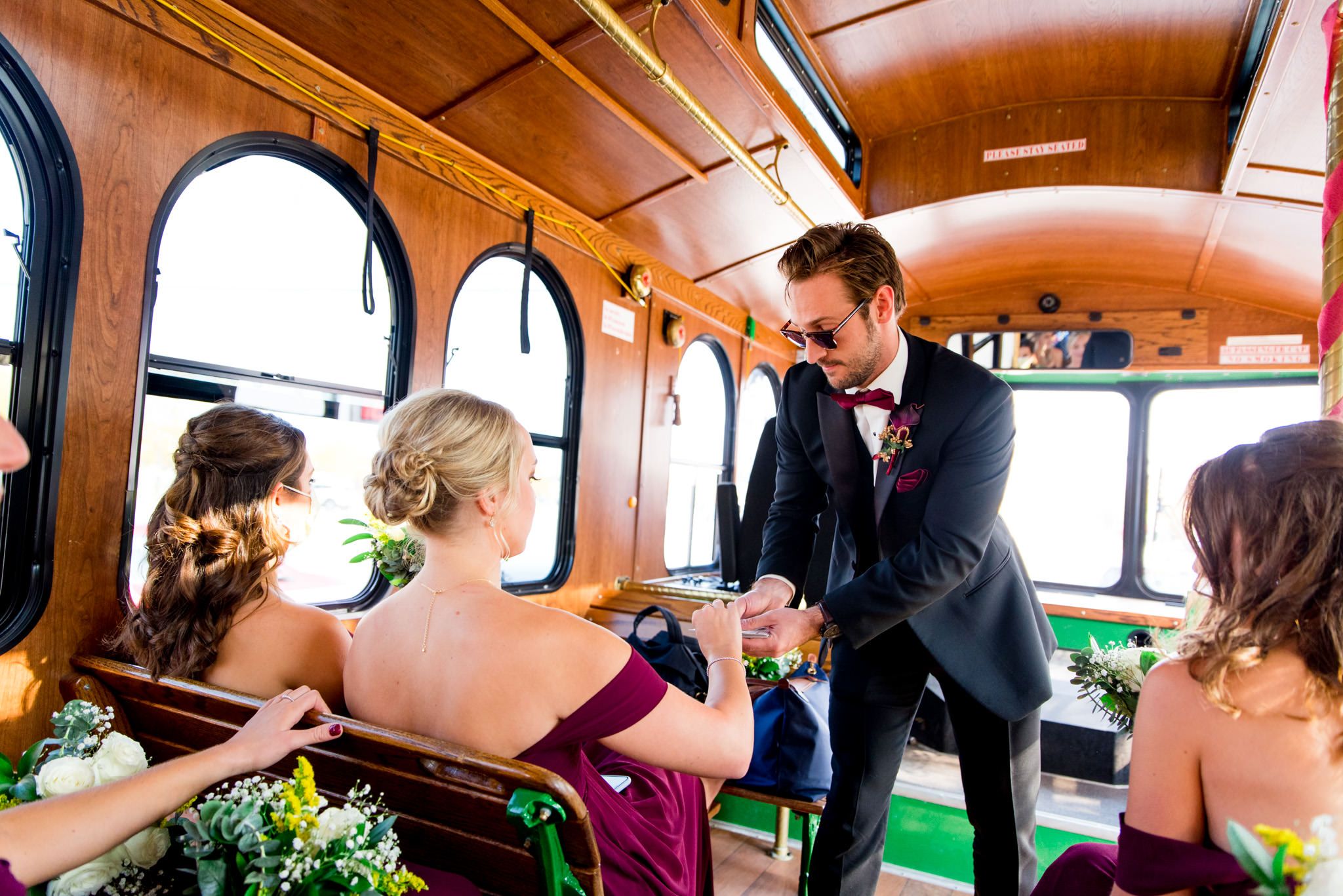 colorful wedding photography captures wedding party in trolley