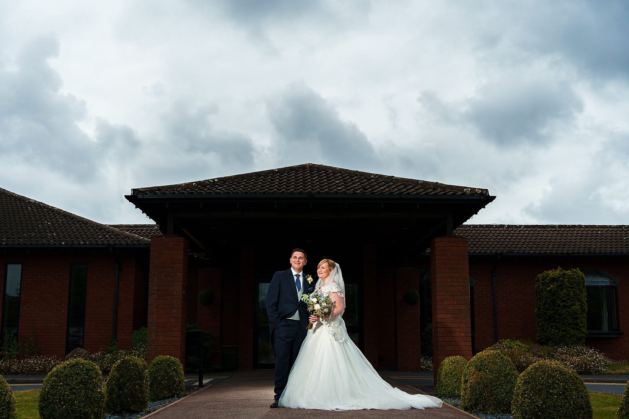 bride and groom couple photograph outside marriot hotel entrance