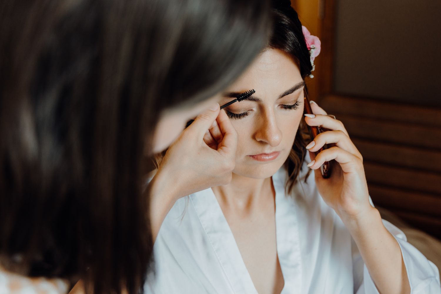 Close-up of wedding day makeup application in natural window light.