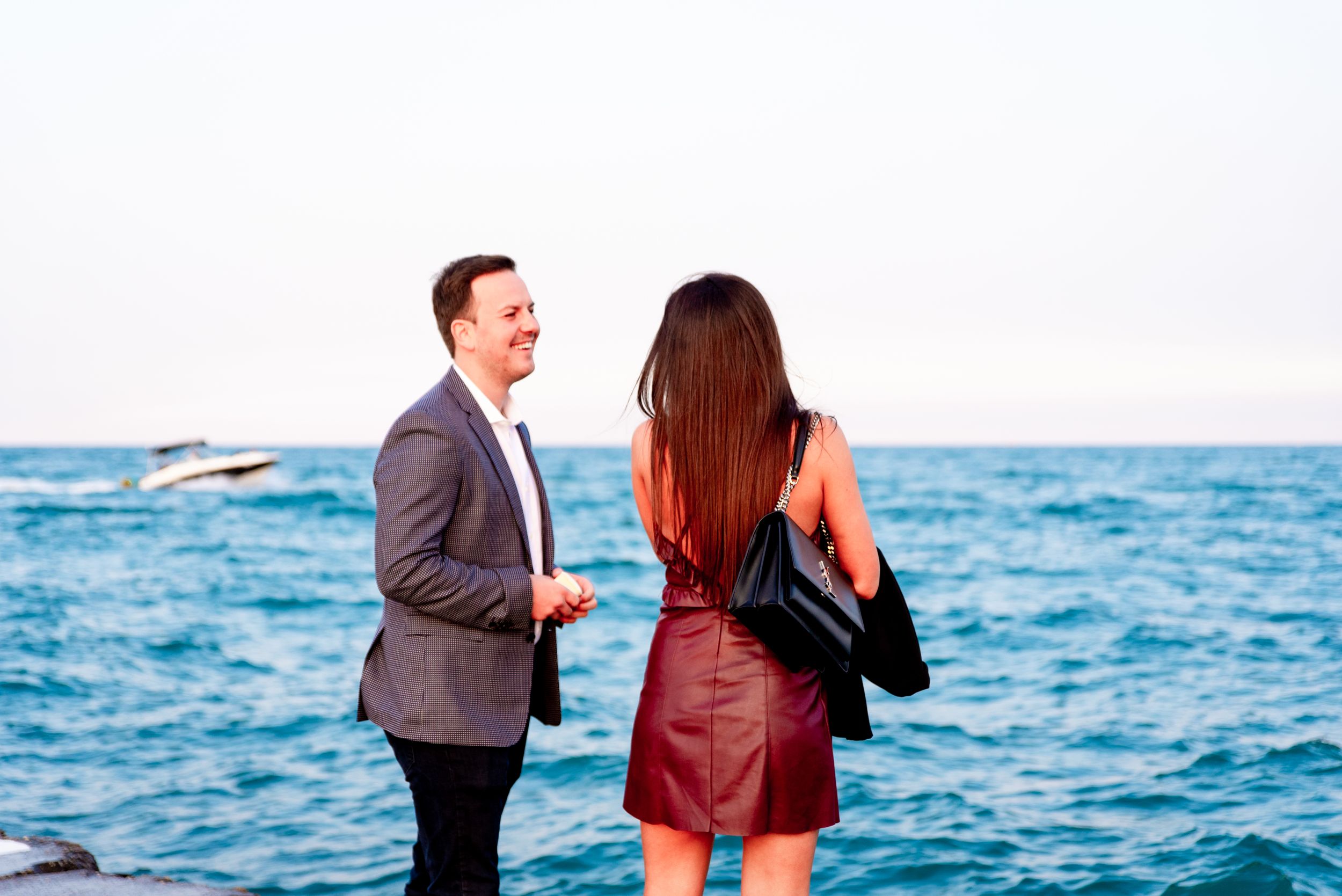 man smiling at his girlfriend before North Avenue Beach Proposal