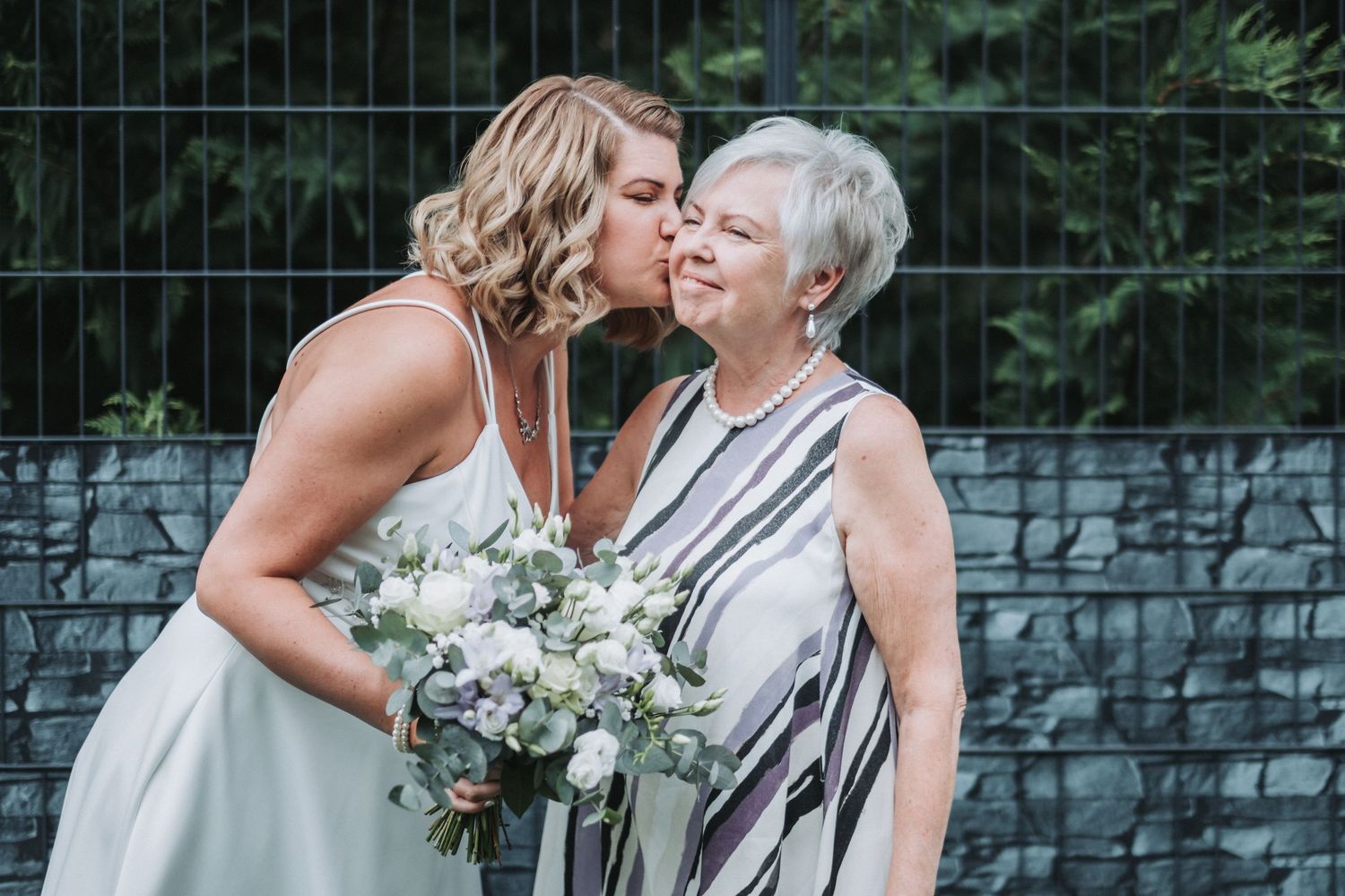 Sweet moment shared between two people at an outdoor wedding venue.