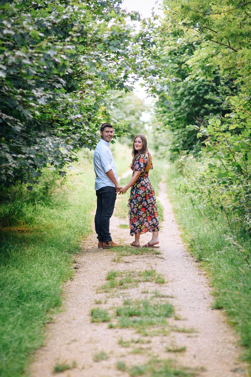 Engagement Photography by Zara Davis Photography, near Stroud, Gloucestershire in the Cotswolds walking looking back