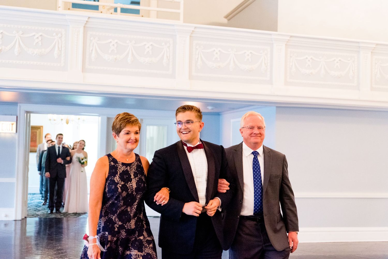 groom and parents walking down the aisle at Woman's Club of Evanston before getting married