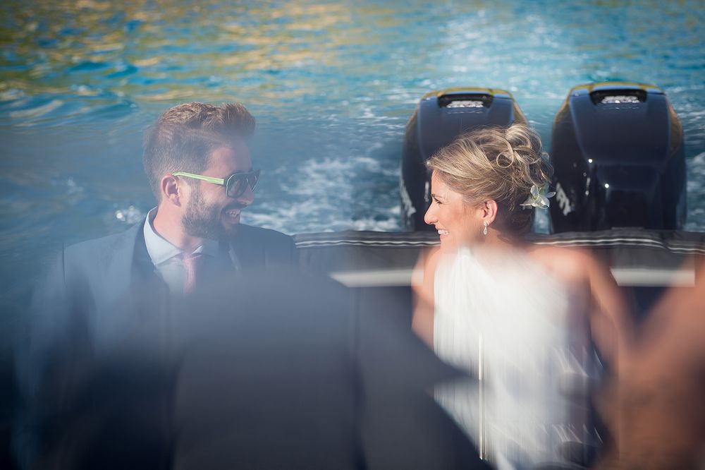 bride looks to her brother while being in the boat which transfers them to wedding ceremony