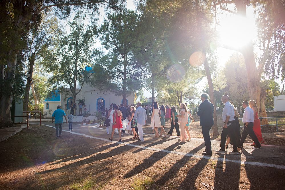 bride and friends walking down the aisle while the sun sets