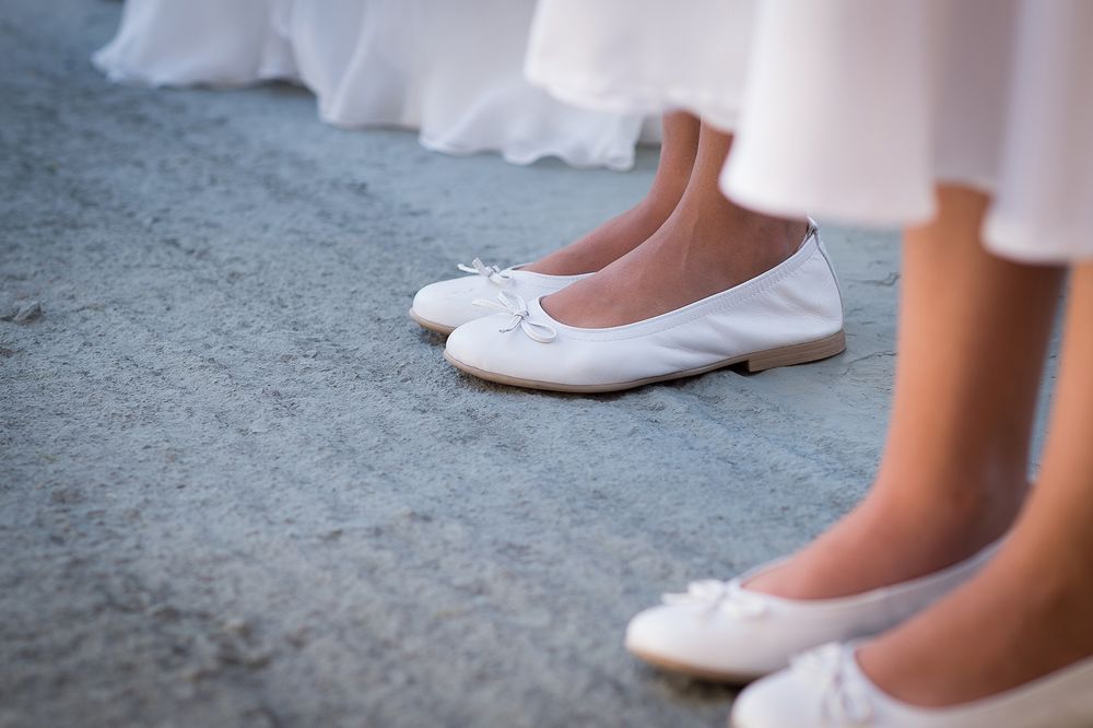 bridesmaids white ballerinas during wedding ceremony