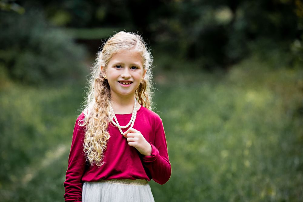 little girl dressed up in red shirt