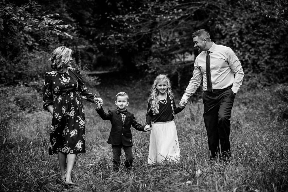 family holding hands in trees
