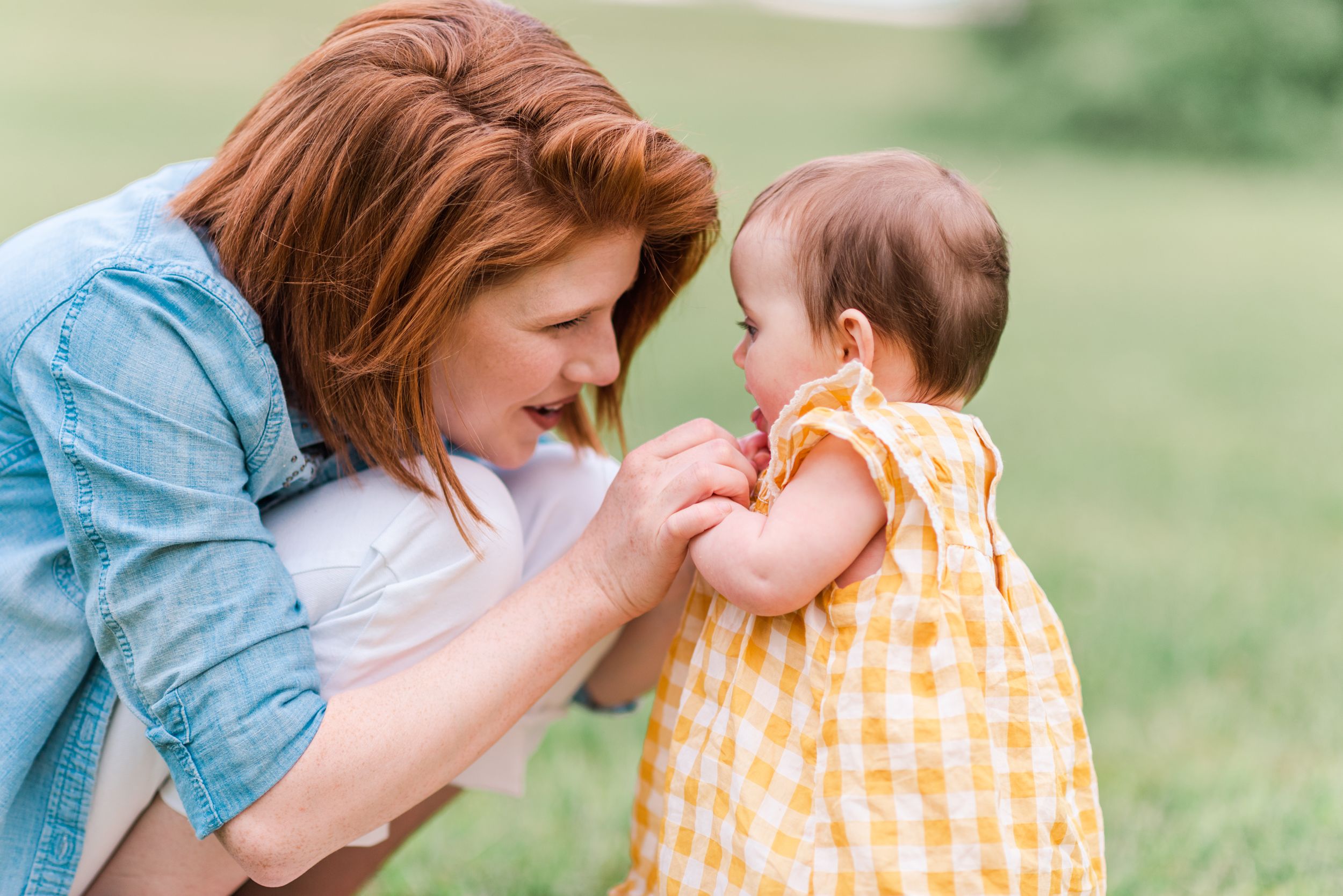 Mom looking lovingly at baby girl at family photos at Moraine State Park, Pennsylvania