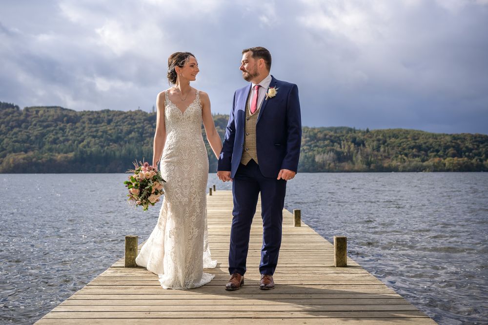 Bride and groom on jetty by Windermere