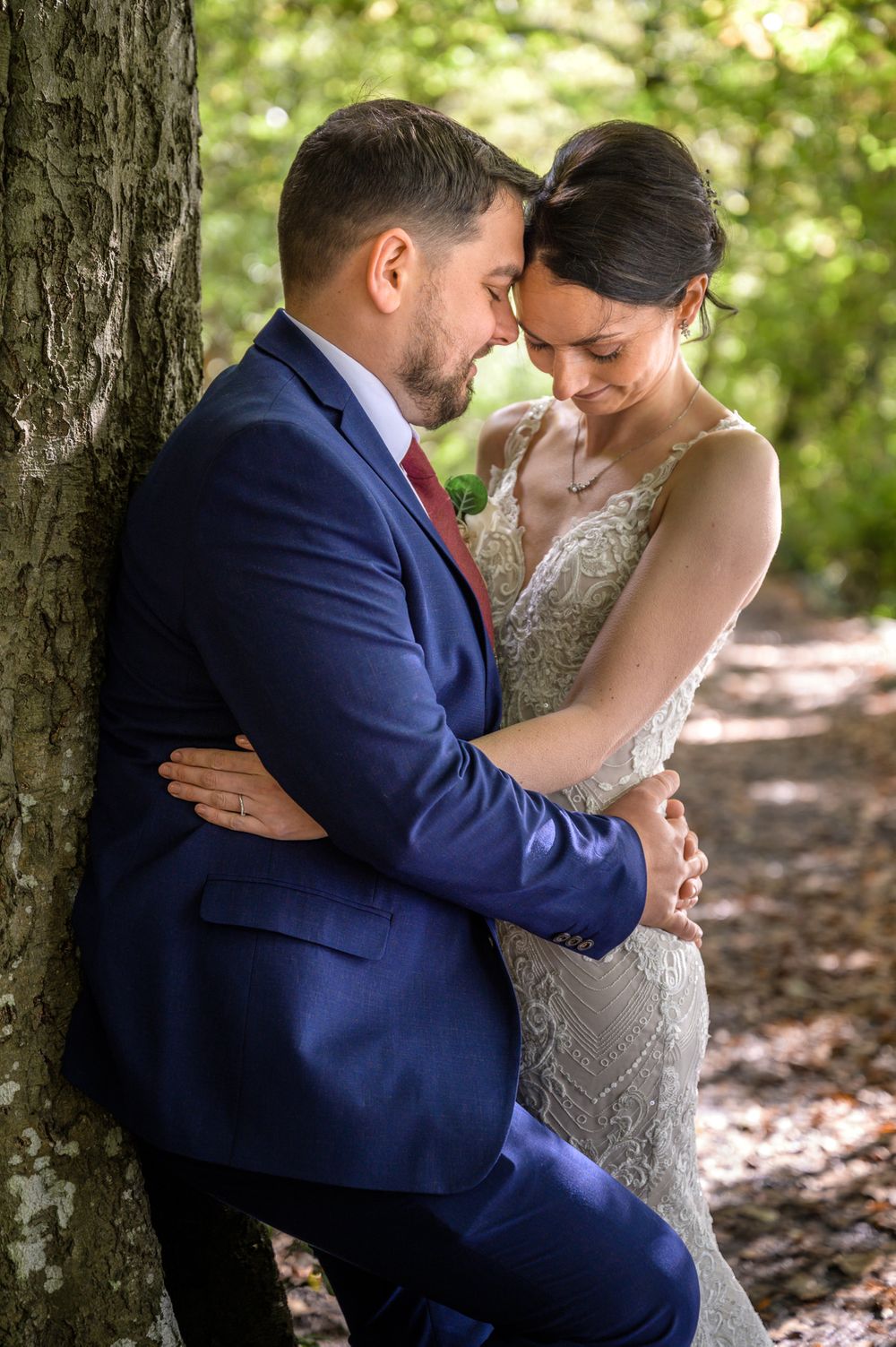 Bride and groom enjoying a moment under a tree