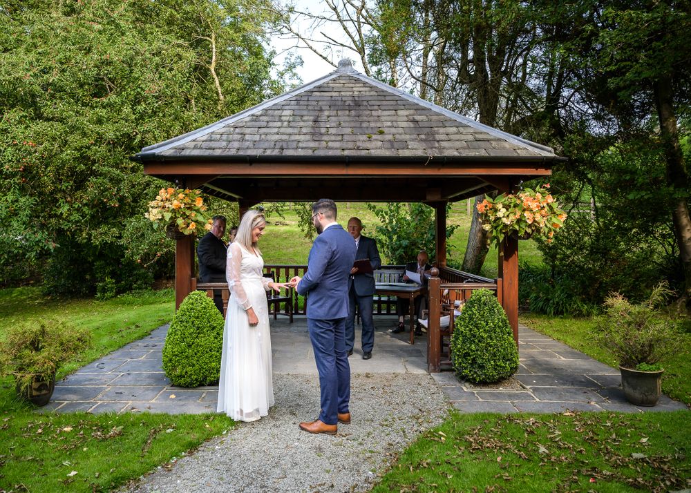 Exchanging rings at outdoor wedding in Lake District