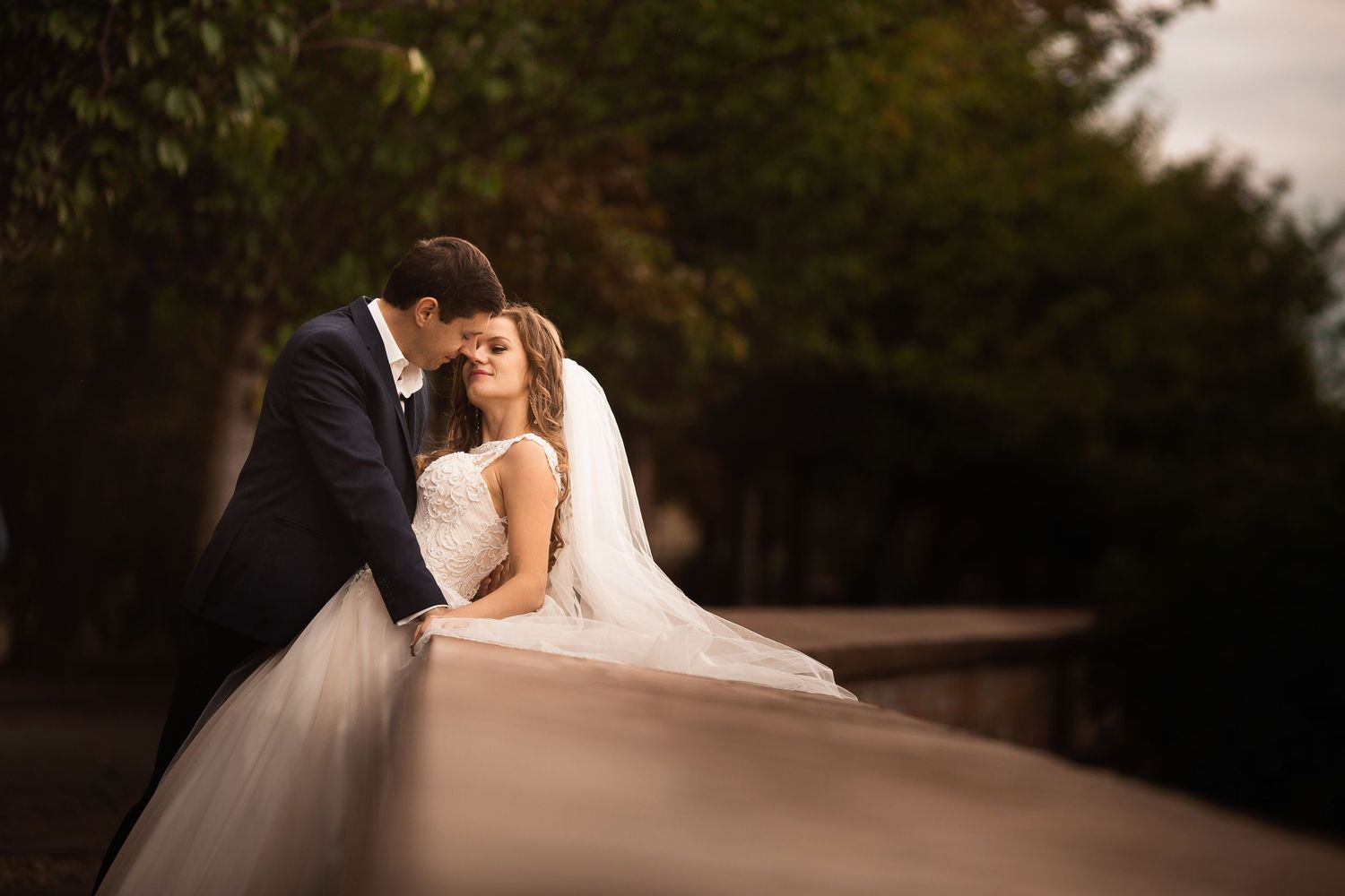 Intimate wedding couple moment captured in soft evening light.