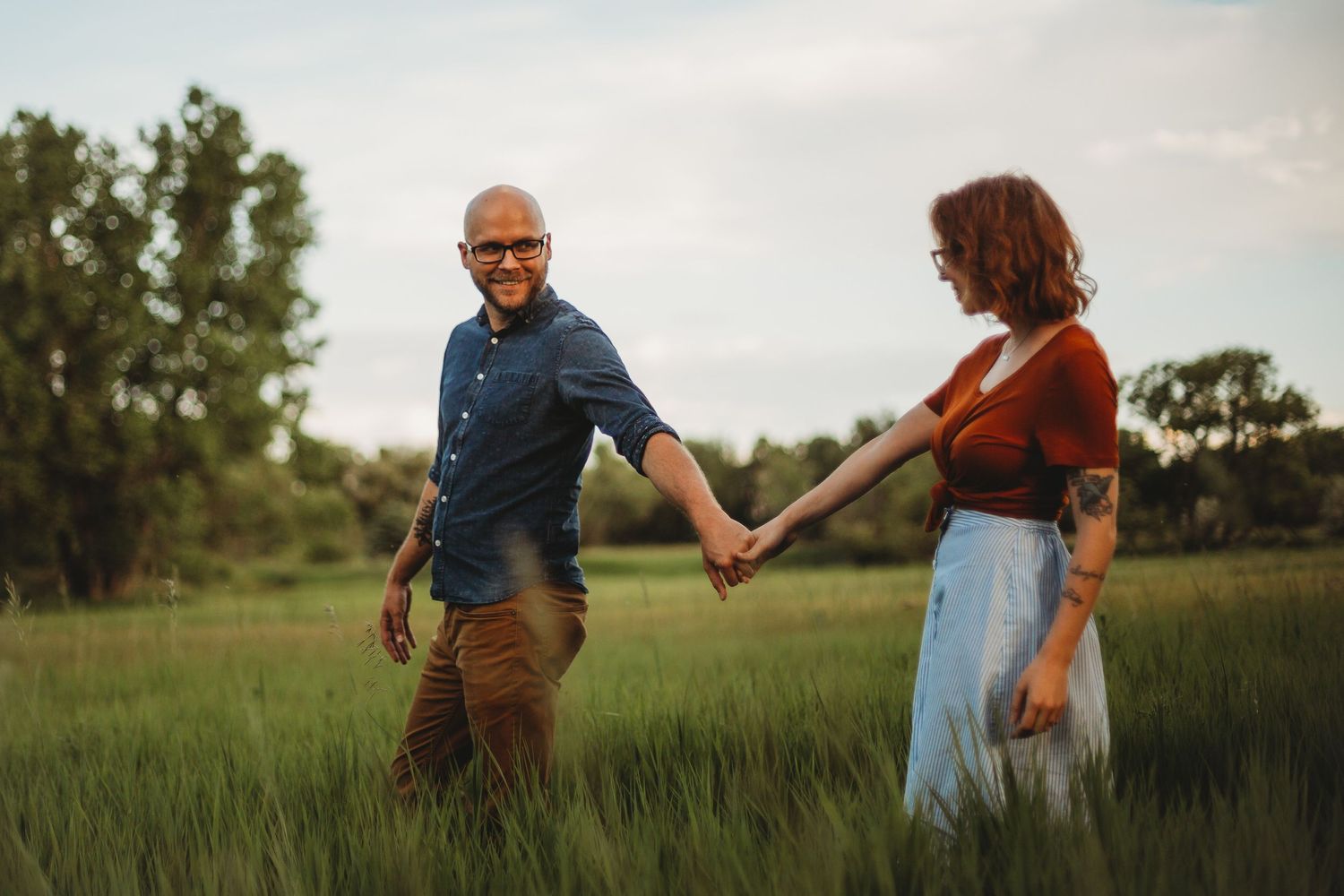 A couple walks along the path at Ross Natural Area during their portrait session in Fort Collins, Colorado.