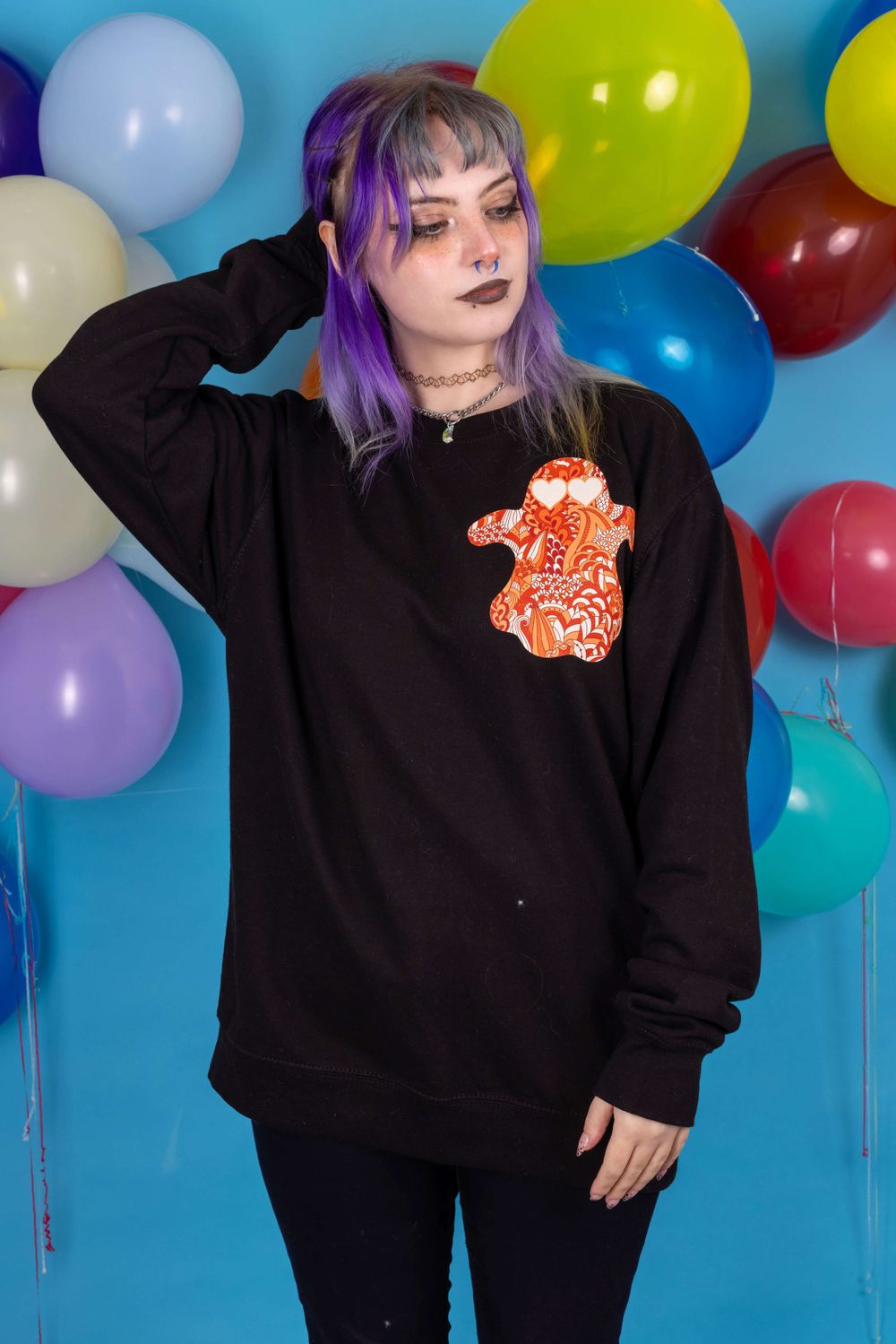 Alternative purple haired white model posing in front of a balloon background for small fashion business Grunge Monkey.