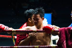 Environmental portrait Thai boxer between rounds in Bangkok