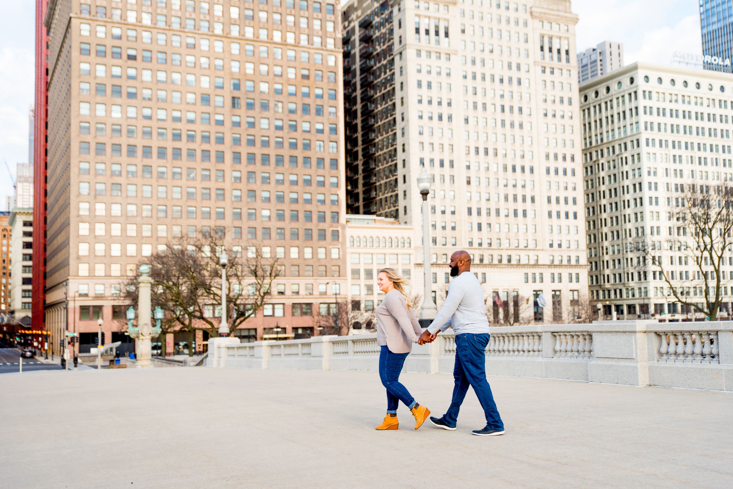 man and woman walking in front of MIchigan Ave for sunrise Chicago wedding pictures
