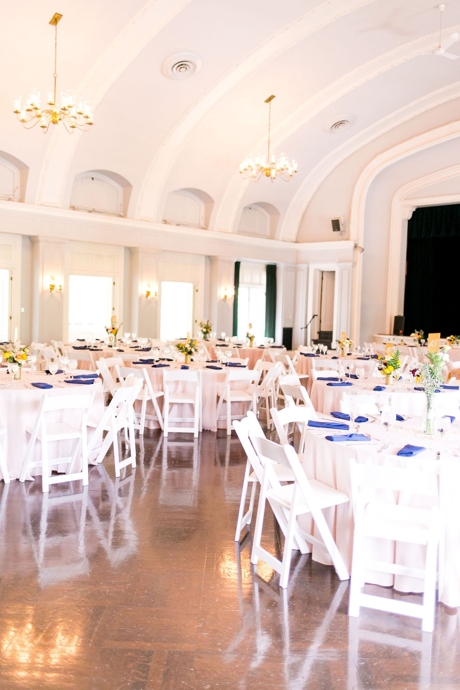 all white chairs and tables with blue napkins at the Woman's Club of Evanston brunch wedding