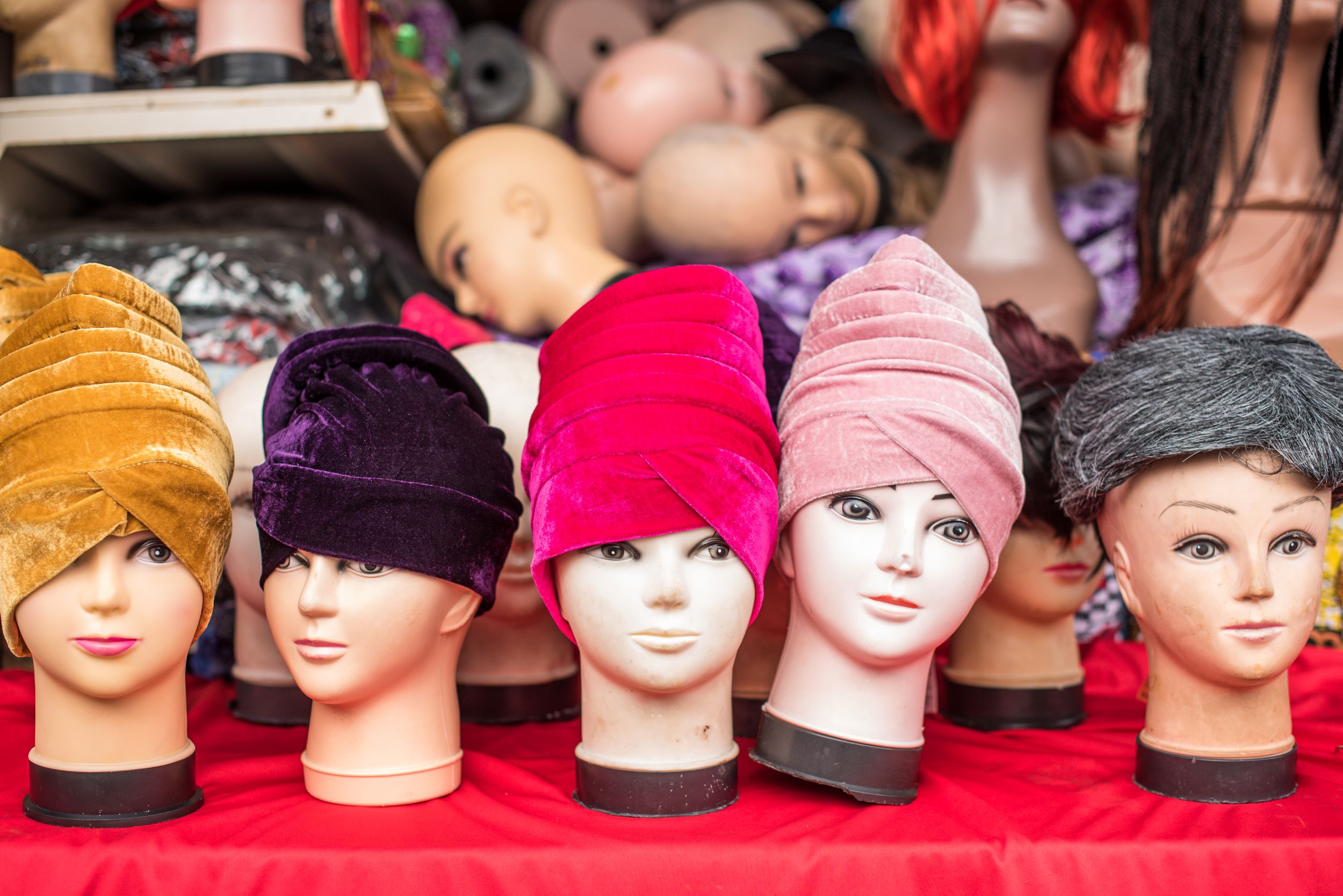 Mannequin heads wearing colorful turbans at Ridley Road Market in London