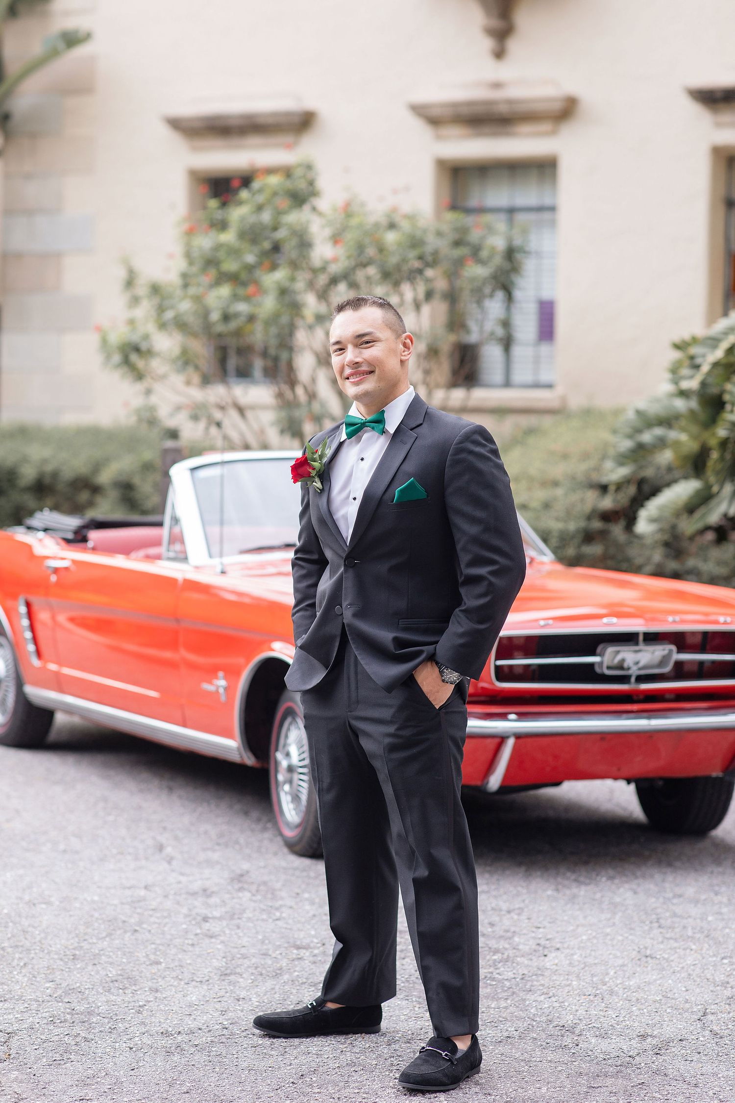 Groom with a red car on a background at the Powel Crosley Estate
