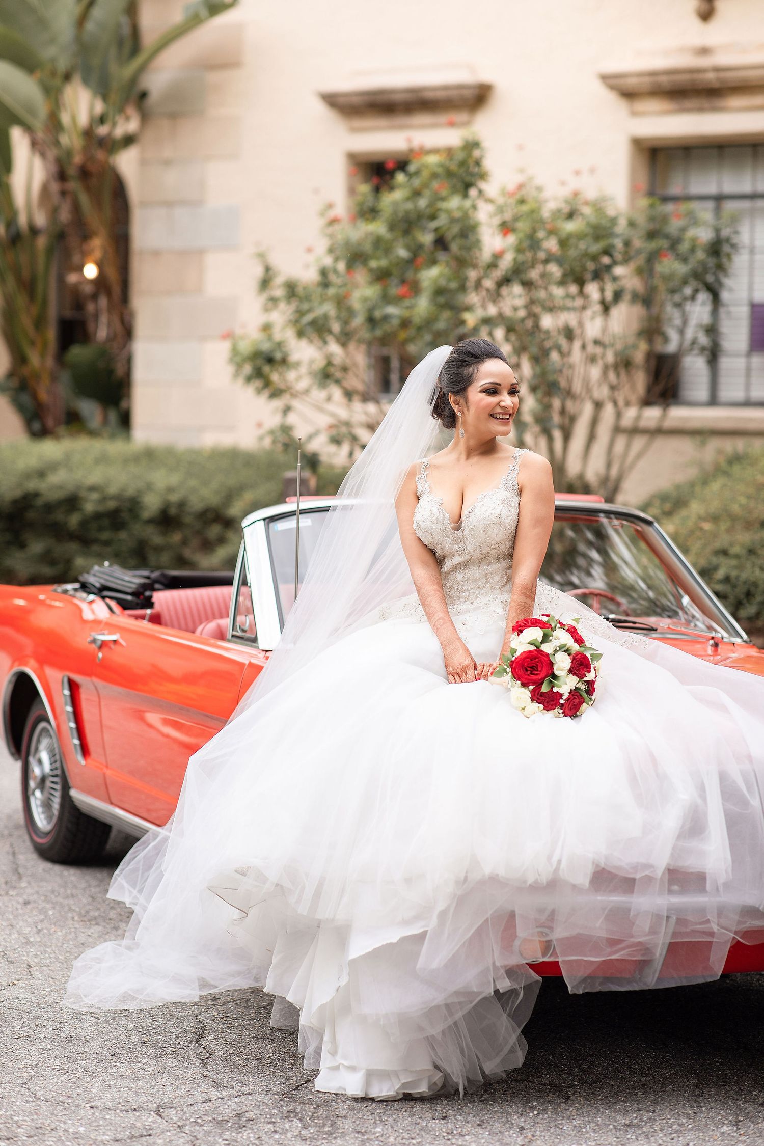 bride with a red car on a background at the Powel Crosley Estate