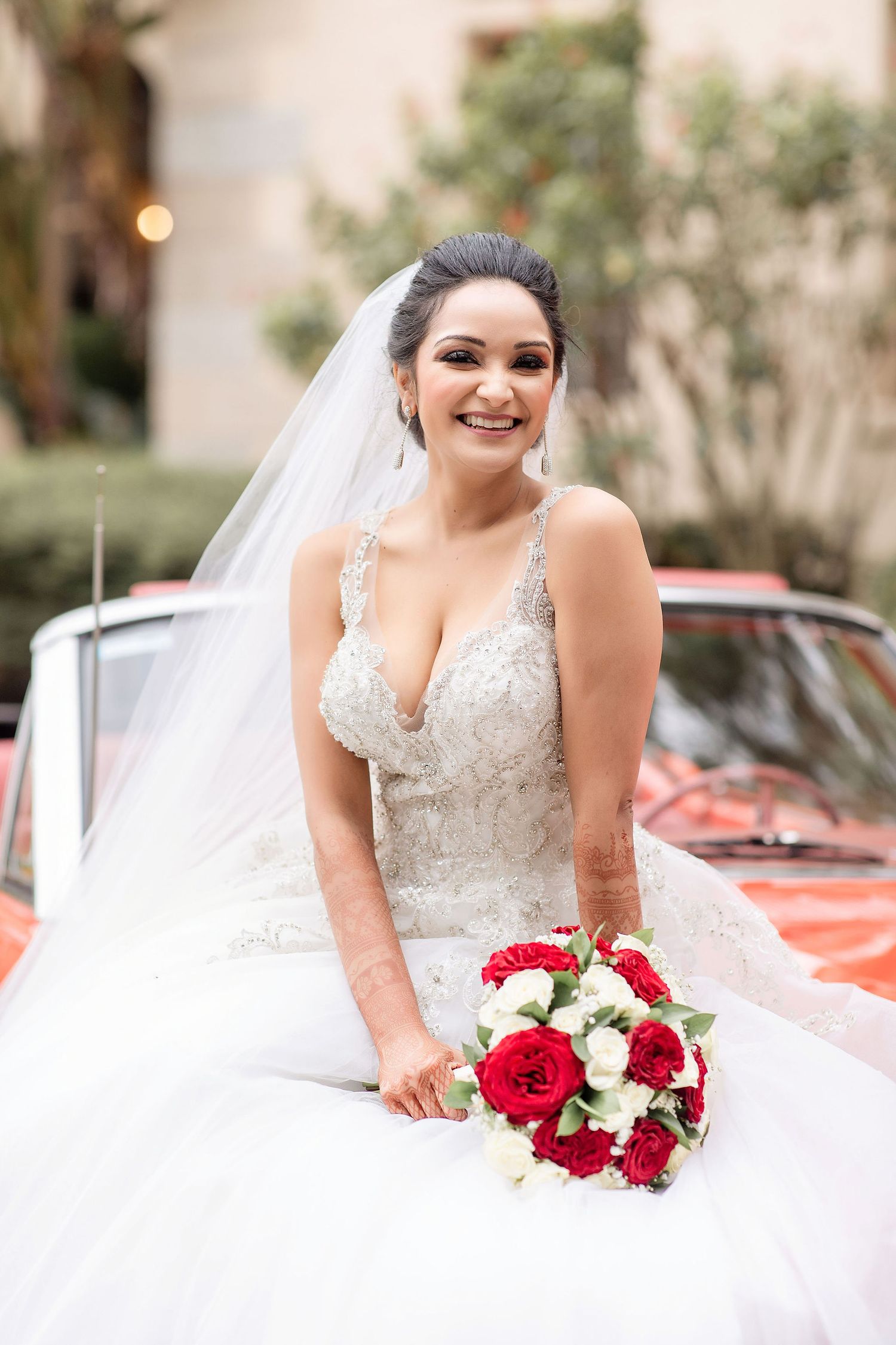 bride with a red car on a background at the Powel Crosley Estate